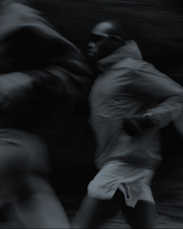 Black and white photo of a man running with motion blur